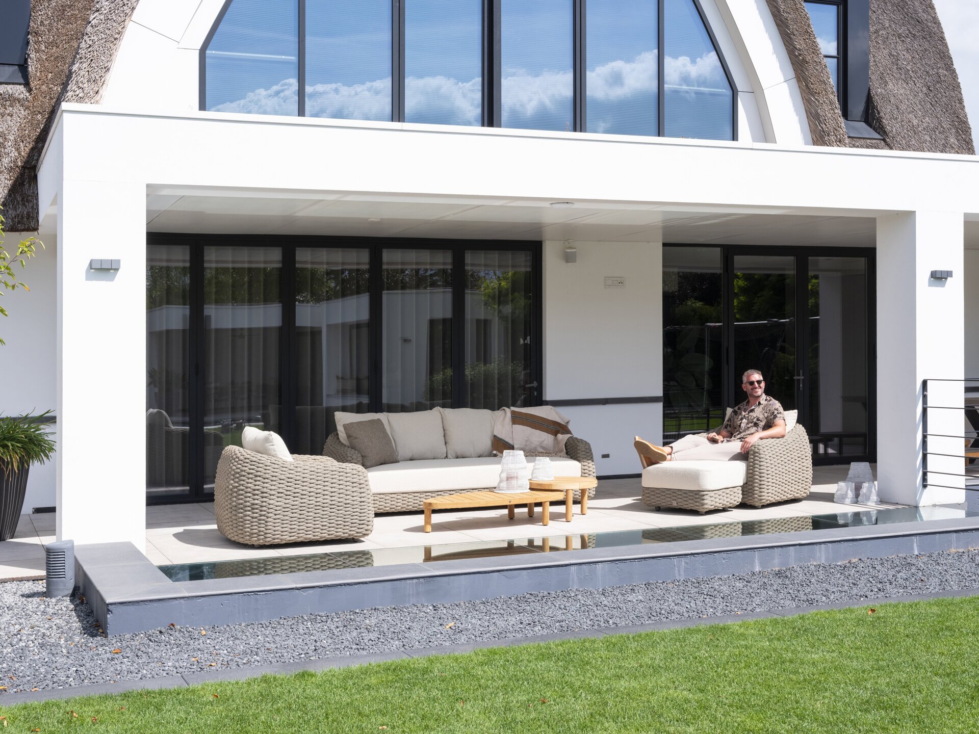 Maxime lounge set with footstool and Finn teak tables outdoor 02.jpg