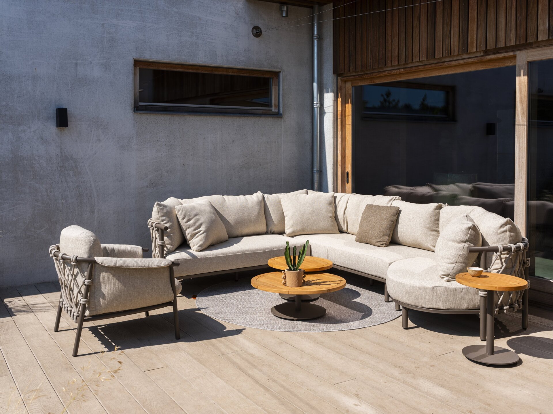 Ezra modular corner with Island and Living chair and Volta tables Terre outdoor 01.jpg